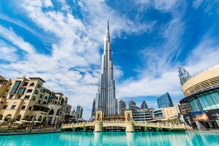 Experience the stunning Burj Khalifa reflecting in serene waters surrounded by the unique blend of modern architecture and rich culture that defines Dubai. A must-see for every traveler.